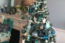 a beach Christmas tree with glass buoy, dolphin, starfish ornaments, green and blue ones, a star tree topper is a cool idea