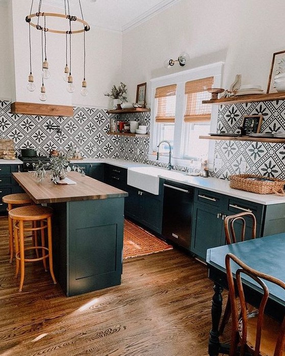 a black farmhouse kitchen with a kitchen island, stained wooden shelves, a bold black and white Moroccan tile backsplash