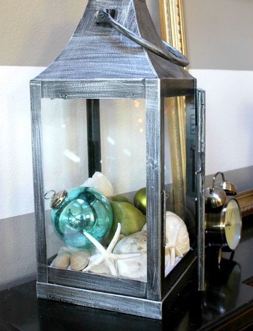 a brushed Christmas lantern with green and turquoise ornaments, seashells and starfish is a lovely decoration for holidays