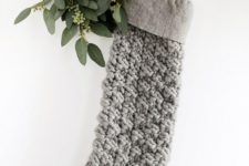 a chunky knit Christmas stocking and some greenery for a minimalist Christmas space