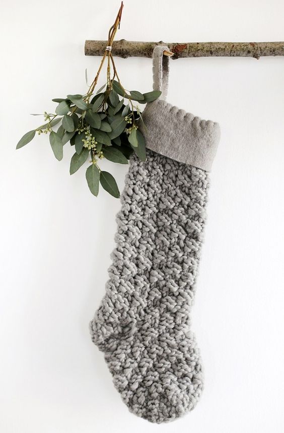 a chunky knit Christmas stocking and some greenery for a minimalist Christmas space