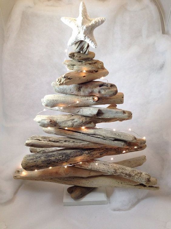 a coastal Christmas tree of driftwood, with lights and with a starfish on top is a cool idea for a beach Christmas space