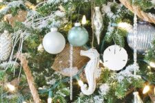 a coastal Christmas tree with white, silver and aqua ornaments, seashells, sea horses, burlap, rope and lights is a gorgeous idea