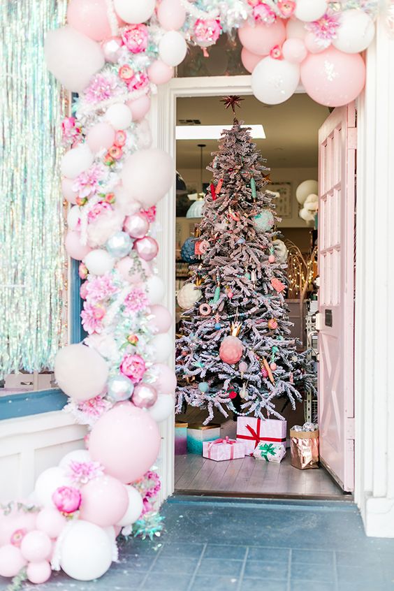 a fantastic pink balloon, pink peony, shiny garland and a Christmas tree with pastel ornaments and beads are amazing for a candy-inspired Christmas celebration