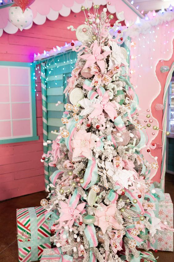 a flocked Christmas tree covered with white and pink fabric blooms, pastel green and pink ribbons, bows and beads is fun