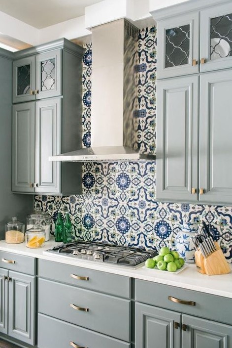 a gorgeous grey farmhouse kitchen with white stone countertops, a bright Moroccan tile backsplash and metallic touches is very elegant