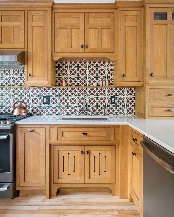 a light stained kitchen with a bright Moroccan tile backsplash and white stone countertops is a lovely idea to rock