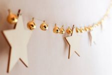 a lovely garland of plywood stars and gold bells is ideal for Christmas, add a shiny touch with them