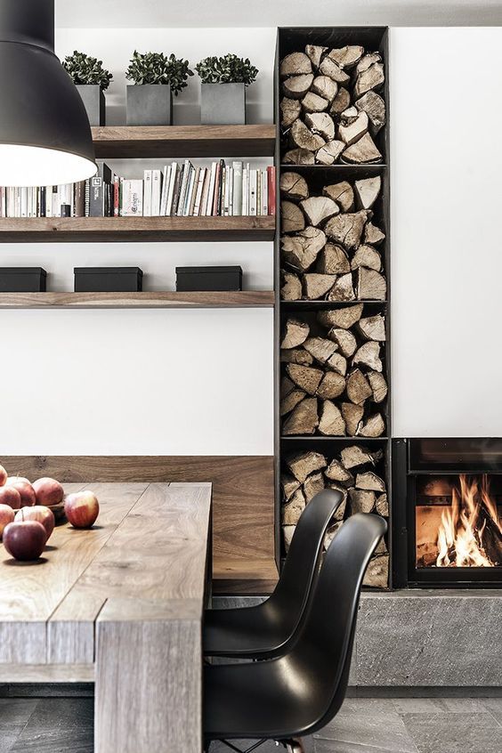 a minimalist built-in fireplace and an open storage unit with firewood for warming and cozying up a minimalist space