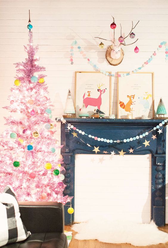 a pastel pink Christmas tree with aqua, green, yellow ornaments and lights is a dreamy and unusual idea for every space