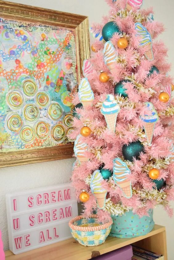 a pastel pink table Christmas tree with gold, teal and ice cream ornaments is a fun and pretty idea for a vintage space