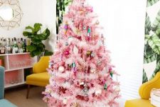 a pink Christmas tree with bright ornaments and fluffy garlands plus a matching bright tree skirt is amazing