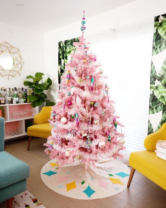 a pink Christmas tree with bright ornaments and fluffy garlands plus a matching bright tree skirt is amazing
