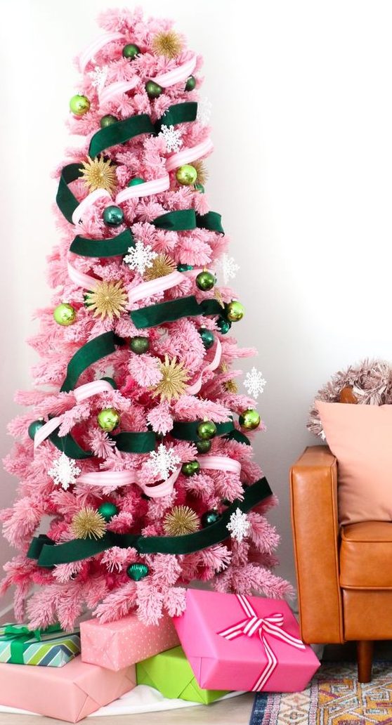 a pink Christmas tree with emerald and neutral ribbons and ornaments in various shades of green plus gold touches