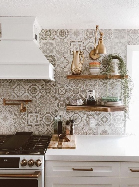 a pretty white kitchen with shaker cabinets, a grey and white Moroccan tile backsplash and stained open shelves