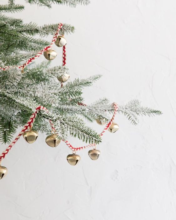 a red twine and mini copper bells can be used to decorate a Christmas tree or something else