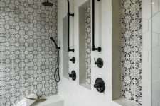 a stylish bathroom clad with grey hexagon tiles, black and white Moroccan tile accents and black fixtures is gorgeous