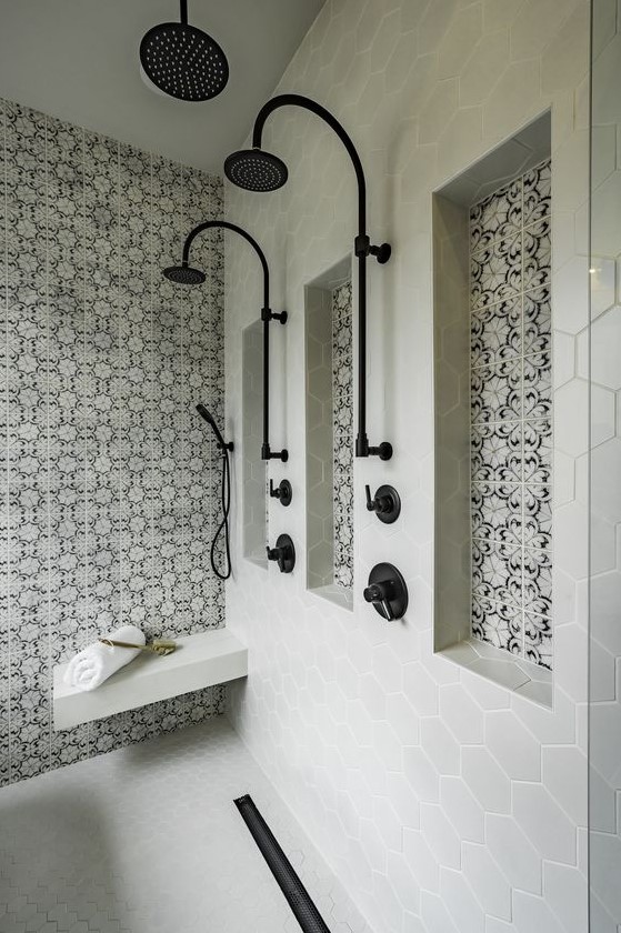 a stylish bathroom clad with grey hexagon tiles, black and white Moroccan tile accents and black fixtures is gorgeous