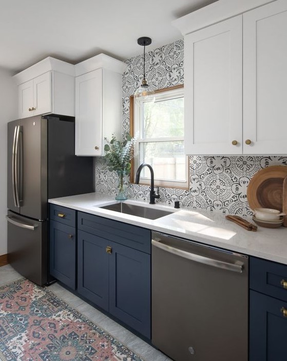 a two-tone kitchen with white and navy cabinets, chic Moroccan tiles on the backsplash, a rug that echoes with them