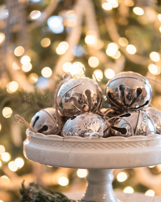 a vintage white stand with vintage silver bells is a chic last-minute Christmas centerpiece or just decoration to rock