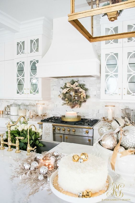 an evergreen Christmas wreath with metallic ornaments, metallic ornaments in bowls, silver ornaments wreaths and candles