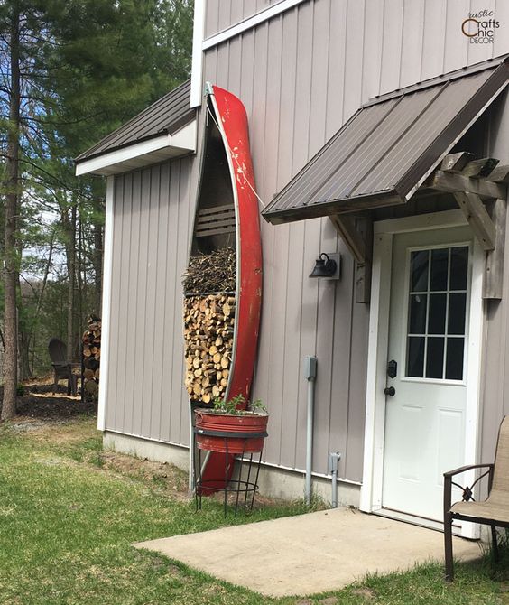 an old canoe used for storing firewood and branches is a very cool idea for any relaxed space