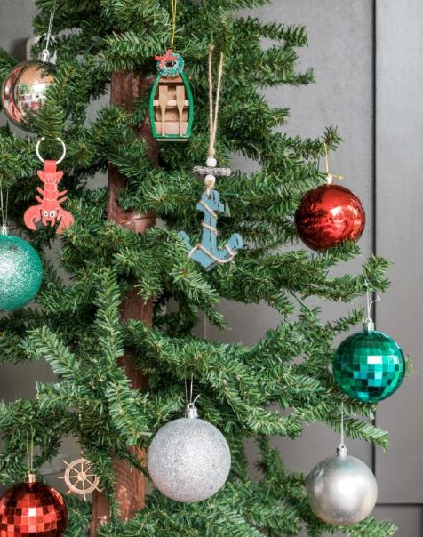 coastal Christmas tree decor with red, green and silver ornaments, anchor, crab and boat ones is amazing