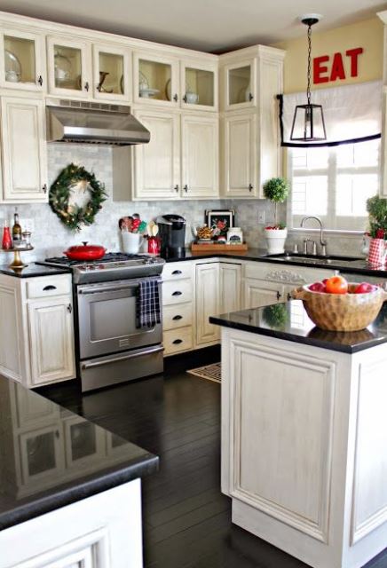 evergreen wreaths and topiaries plus red touches for a farmhouse Christmas feel in the space
