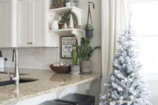 flocked Christmas trees with wooden bead garlands will bring a slight Christmas feel to the space