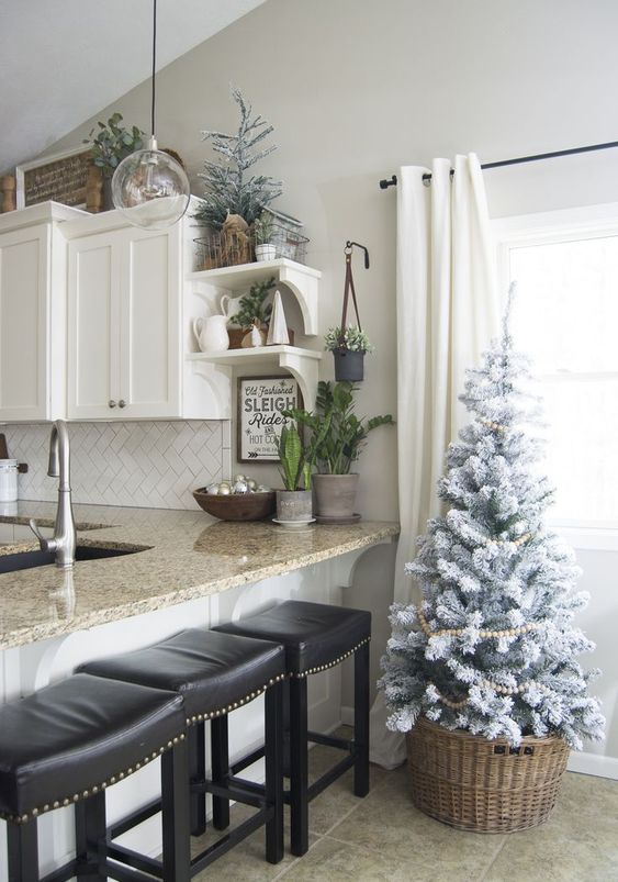 flocked Christmas trees with wooden bead garlands will bring a slight Christmas feel to the space