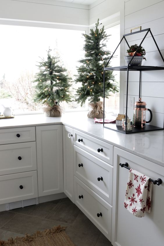 mini Christmas trees with lights wrapped in burlap will instantly make your space feel like holidays