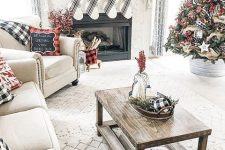 plaid farmhouse Christmas decor with plaid pillows, flocked garlands and flocked Christmas trees decorated with ribbons