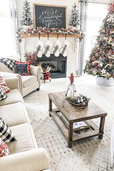 plaid farmhouse Christmas decor with plaid pillows, flocked garlands and flocked Christmas trees decorated with ribbons