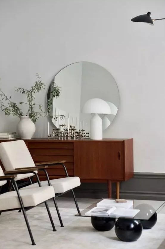 a beautiful dark-stained sideboard with doors and carved out handles and cone legs is a lovely idea for a modern living room