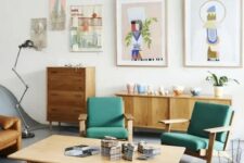 a bright mid-century modern living room with stained furniture, green chairs, an amber leather sofa, a low coffee table, a gallery wall and beautiful potted plants