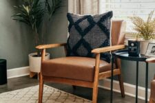 a classic mid-century modern brown leather chair with a boho pillow is a lovely addition to a mid-century modern sapce