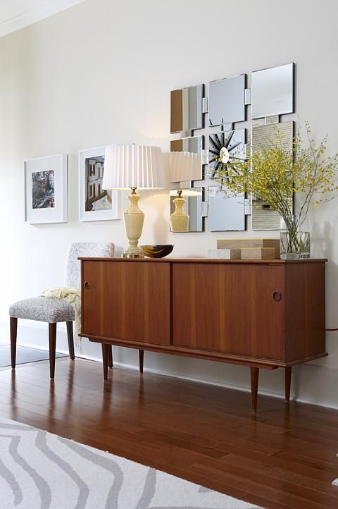 a classy rich-stained mid-century modern sideboard with two sliding doors on cone legs is a lovely idea for a modern space