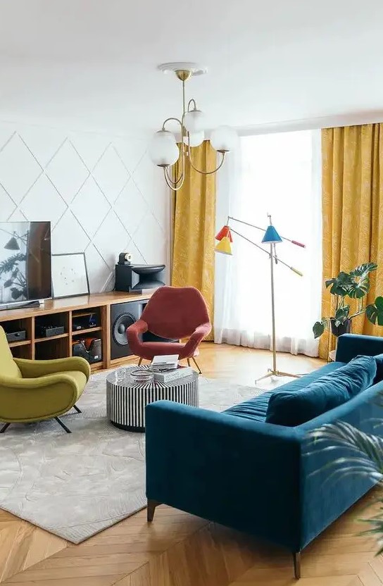 a colorful living room with a stained storage unit, a navy velvet sofa, a striped coffee table, colorful chairs, a bright floor lamp and a paneled wall