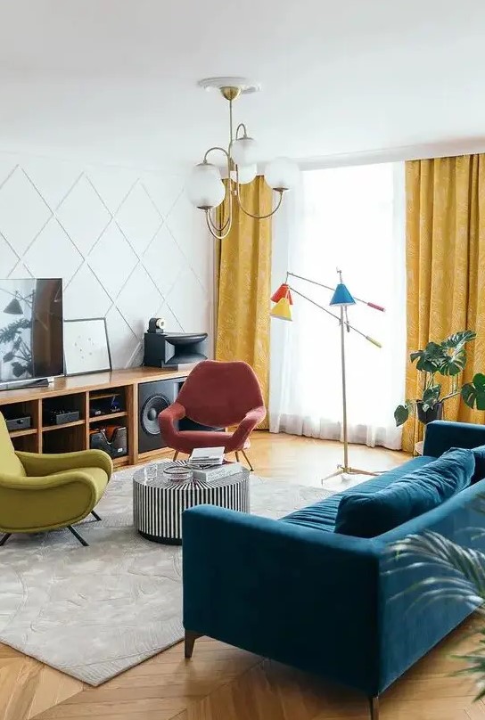 a colorful living room with a stained storage unit, a navy velvet sofa, a striped coffee table, colorful chairs, a bright floor lamp and a paneled wall