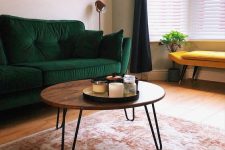 a cool mid-century modern coffee table with a rich stained round tabletop and hairpin legs is pure elegance and timeless style for your living room