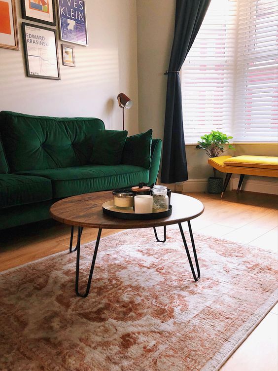 a cool mid-century modern coffee table with a rich stained round tabletop and hairpin legs is pure elegance and timeless style for your living room