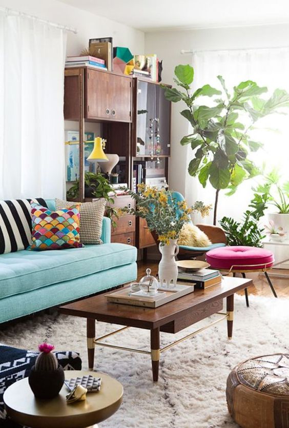 a cool rich-stained coffee table with a small drawer and gold accents is a gorgeous idea for a mid-century modern space