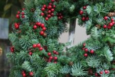a fab Christmas wreath of evergreens, pinecones and cranberries is a very beautiful and cool front door decoration