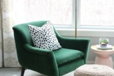 a green velvet chair with a polka dot pillow, a woven ottoman, a fur rug and a metal floor lamp