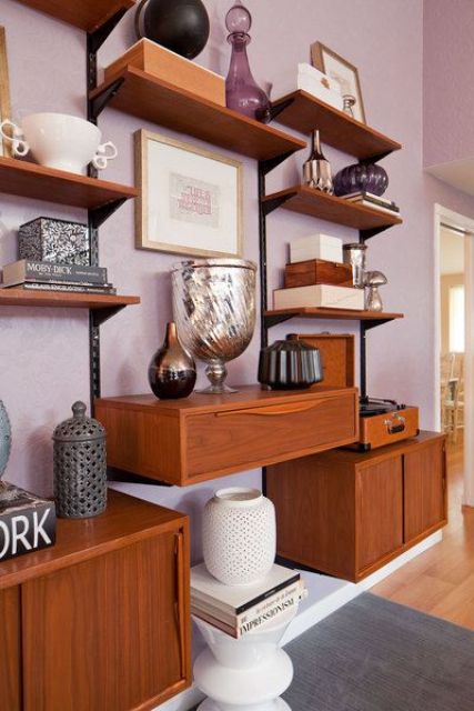 a large mid-century modern wall unit with closed compartments, a drawer and asymmetrically placed open shelves