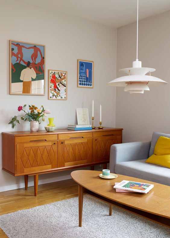 a light-stained sideboard with cutout handles and carved patterns on tall cone legs is a lovely and cool idea for your living room