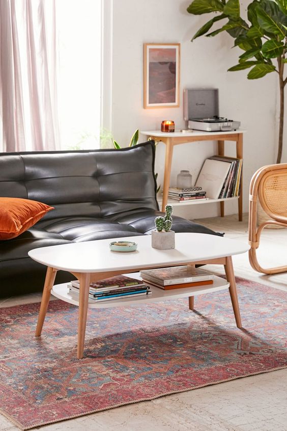 a lovely and cute two-tiered coffee table with white tabletops and light-stained legs is a cool solution for a mid-century modern living room