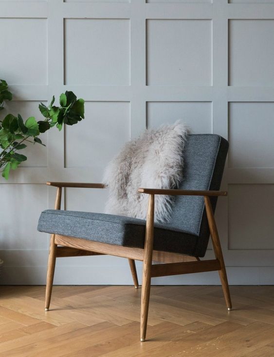 a mid century modern chair with a stained frame and legs, grey upholstery is always a comfortable and cool idea