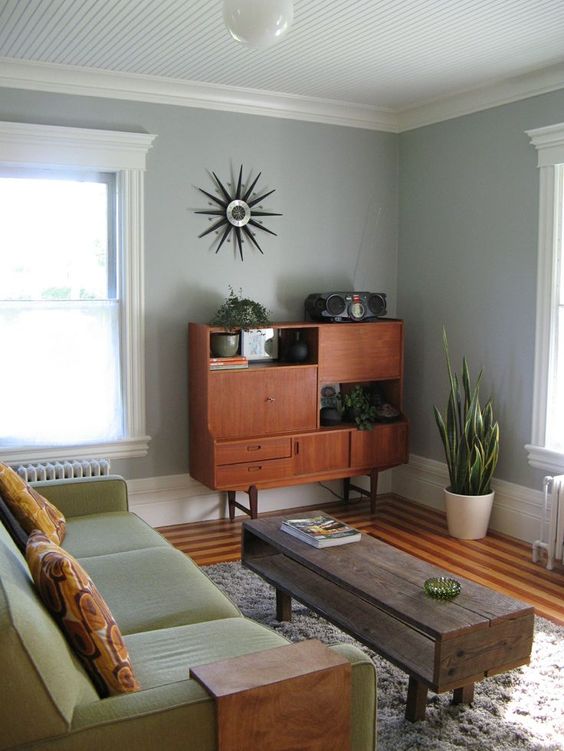 a mid-century modern coffee table of reclaimed wood, with rather dark stain and an open storage space