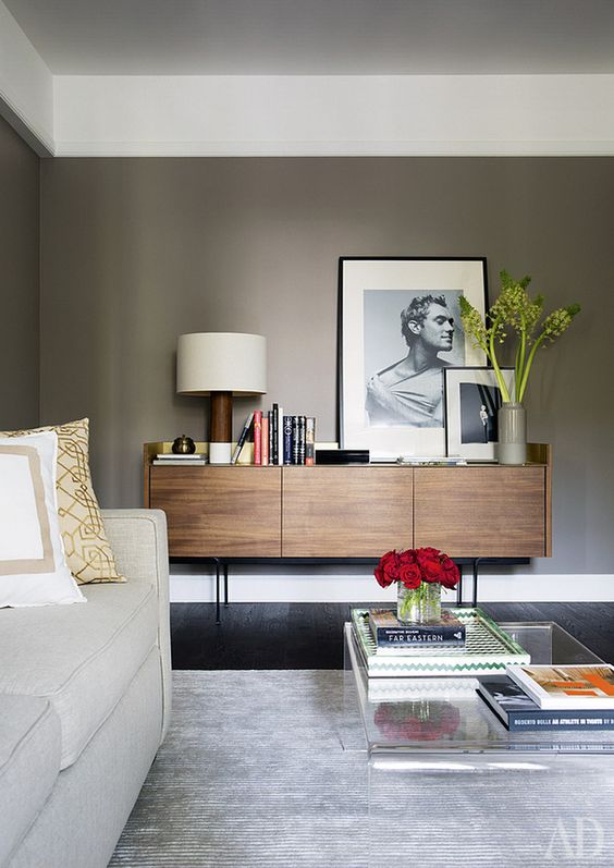 a mid-century modern stained sideboard with sleek doors with no handles and thin metal legs is a lovely idea to rock